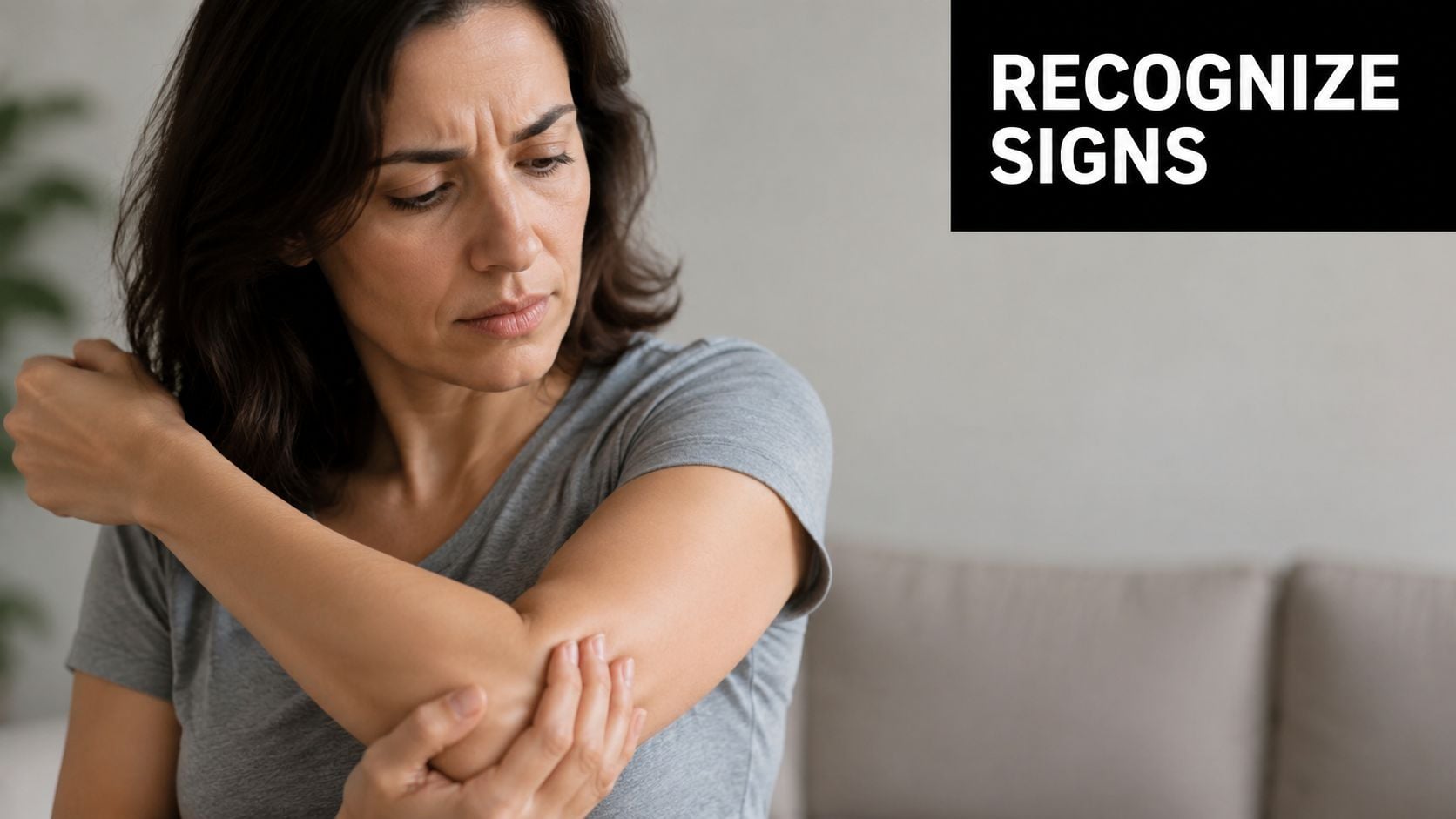A woman experiencing discomfort in her elbow, representing the symptoms and need to recognize medical signs.